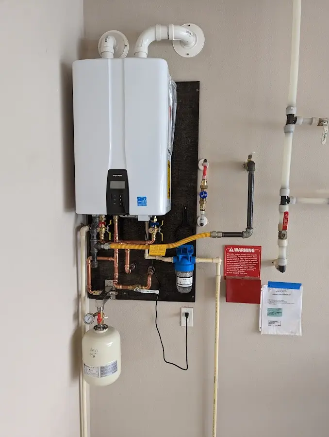 Professional plumber installing copper piping in a Bellevue home